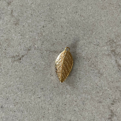 Thin golden leaf charm