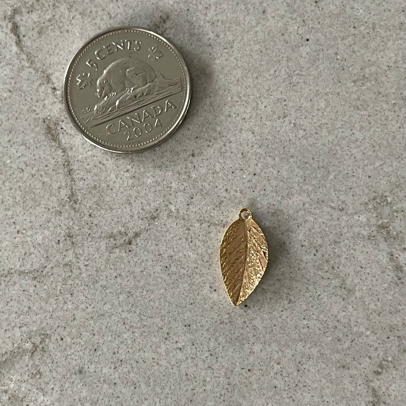 Thin golden leaf charm