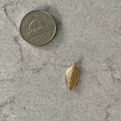 Thin golden leaf charm