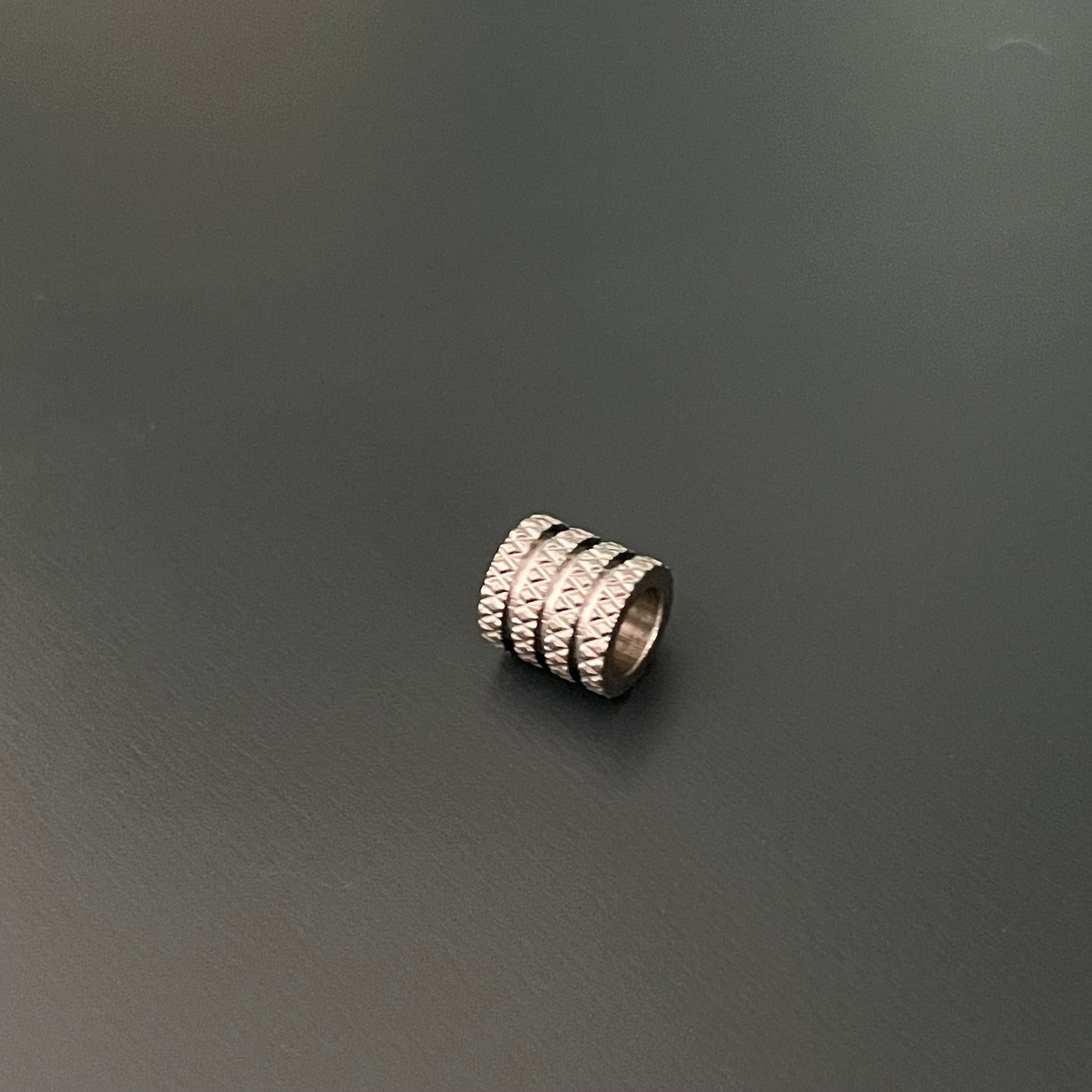 Grooved column charm, diamond patterns