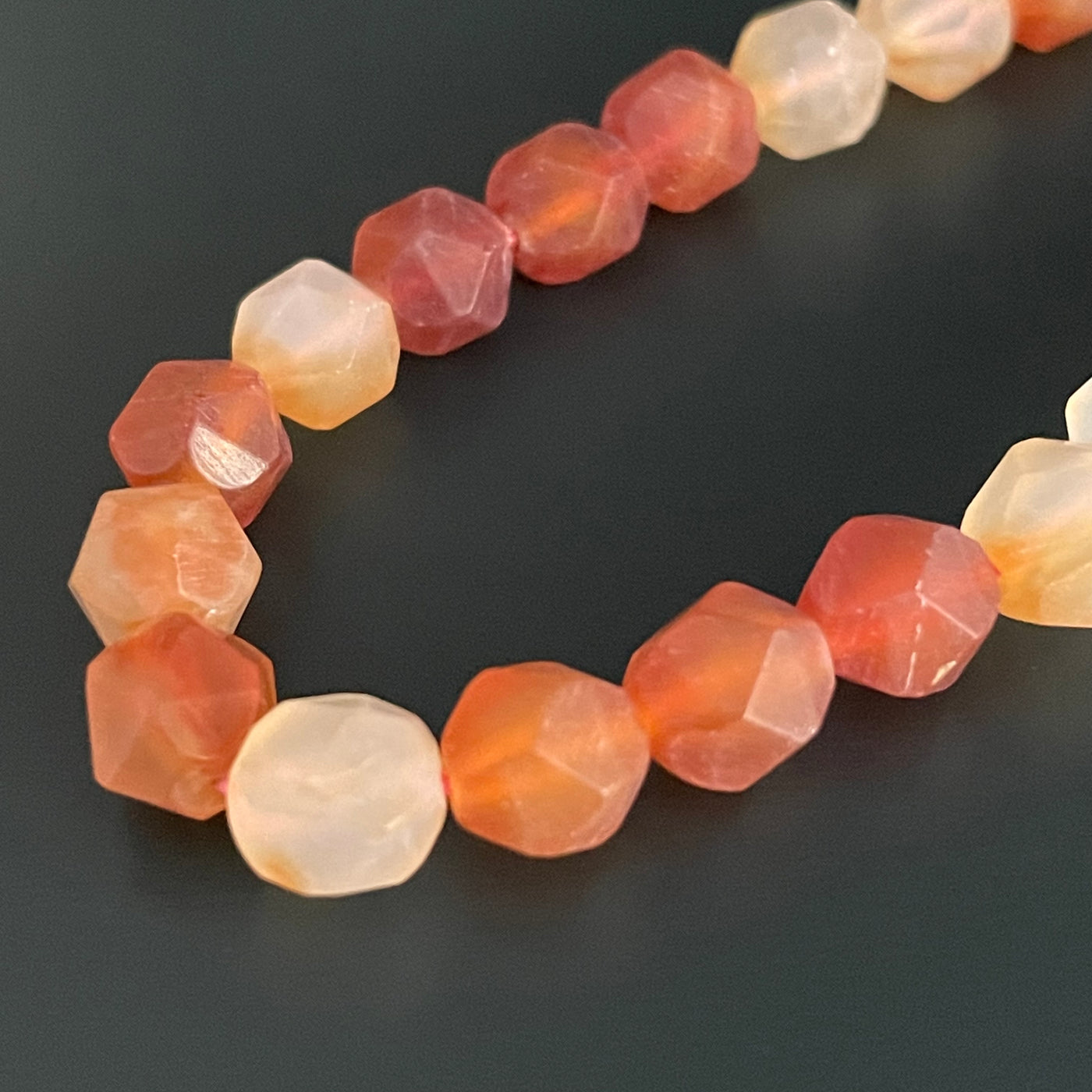 Triangular faceted orange carnelian cord