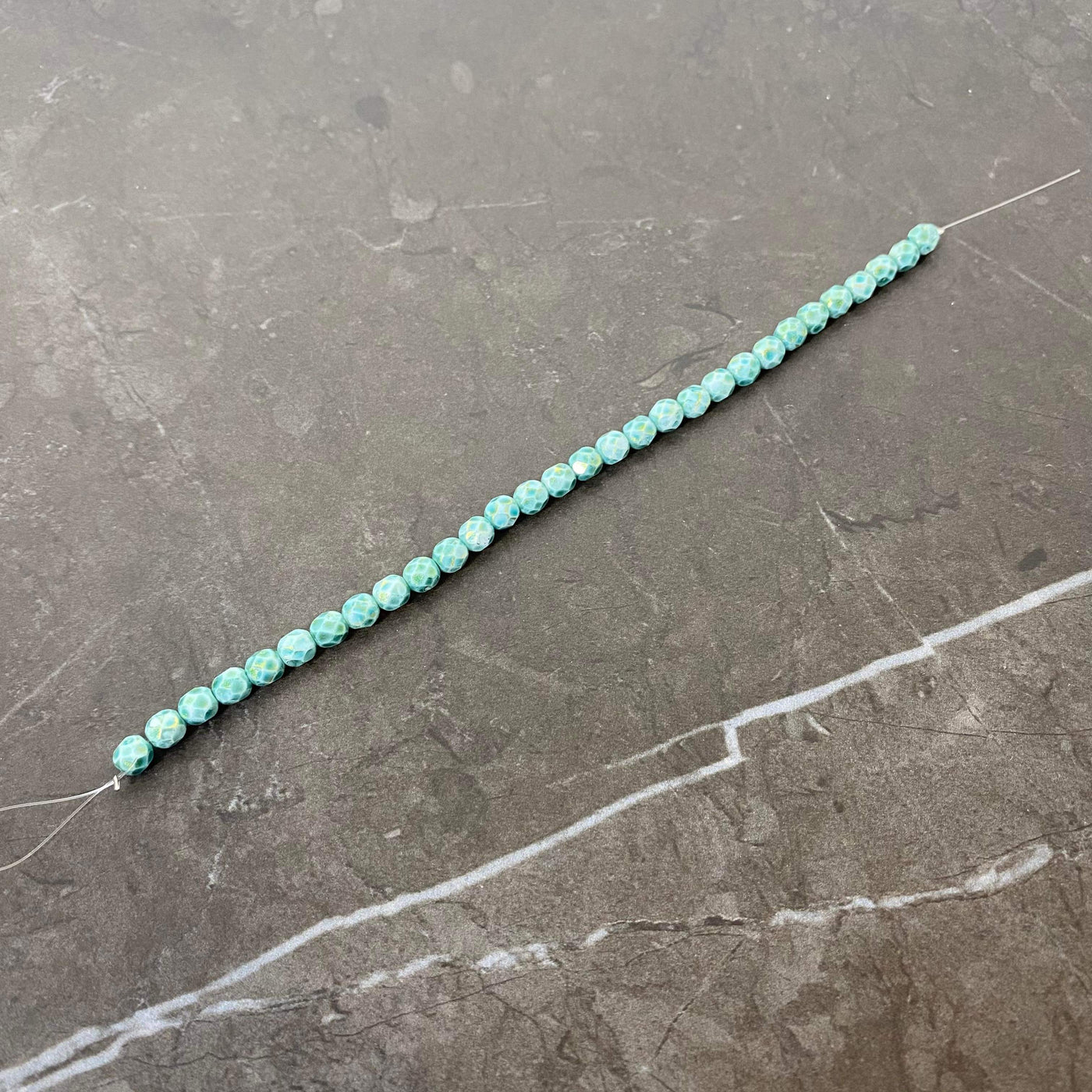 Gold-tinted turquoise faceted Czech glass rope 6 or 8 mm.